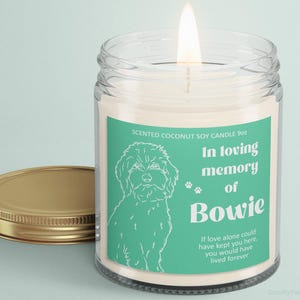 May include: A teal and white scented coconut soy candle with a dog silhouette and the text "In loving memory of Bowie. If love alone could have kept you here, you would have lived forever."