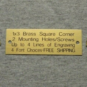 May include: A gold-colored metal plaque with the text "1x3 Brass Square Corner, 2 Mounting Holes/Screws, Up to 4 Lines of Engraving, 4 Font Choices-FREE SHIPPING".