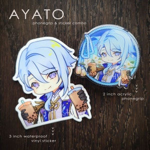 May include: A sticker combo featuring a 3 inch waterproof vinyl sticker and a 2 inch acrylic phone grip. Both stickers feature a cartoon character with blue hair holding a cup of boba tea. The text "AYATO phonegrip & sticker combo" is at the top of the image.