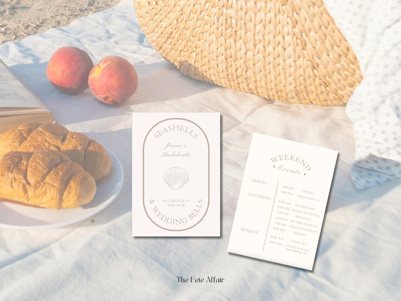 May include: Two white cards with text on a white tablecloth. The first card says "Seashells & Wedding Bells" with a seashell graphic. The second card says "Weekend Events" with a list of events for Friday, Saturday, and Sunday.