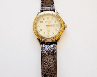 Reloj Wenger Swiss Army de cuarzo vintage de 29 mm con hora mundial, fecha y correa de cuero.