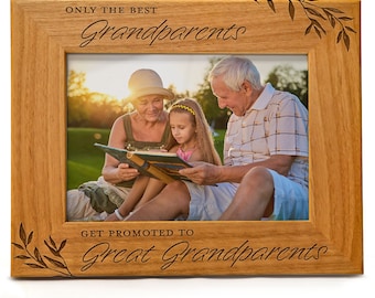 May include: A wooden photo frame with an engraved message that reads "Only the best grandparents get promoted to great grandparents". The frame features a picture of a family of three, a grandmother, grandfather, and a young girl, reading a book together in a park.