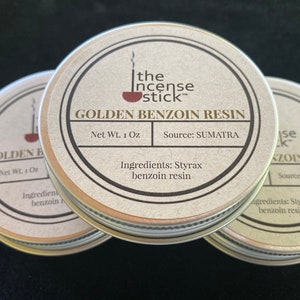 May include: Three round metal tins with lids, each containing golden benzoin resin. The label on the front tin reads "The Incense Stick" and "Golden Benzoin Resin". The label also states "Net Wt. 1 Oz" and "Source: SUMATRA". The label on the front tin also lists the ingredients as "Styrax benzoin resin".