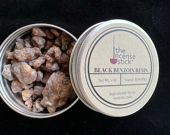 May include: A silver tin containing Black Benzoin Resin, with the lid beside it. The lid displays the text "the Incense Stick" and "BLACK BENZOIN RESIN". The tin contains pieces of resin, with a net weight of 1 oz.
