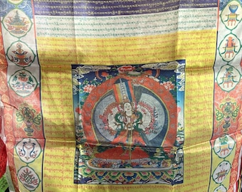 May include: A colorful Tibetan prayer flag with a central image of a deity holding a white umbrella. The flag is surrounded by a border of intricate patterns and text in Tibetan script. The text reads "White Umbrella".