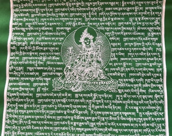 May include: Green fabric prayer flag with white text and a white image of a deity. The text includes the words "Tara" and "Om".