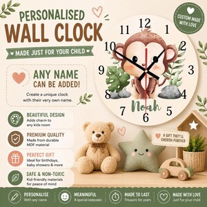 May include: A round wall clock featuring a cartoon monkey illustration, black clock hands, and the name Noah printed in green. The clock face includes numbers one through twelve and green foliage accents on a cream background with text.