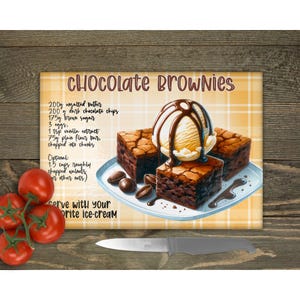May include: A yellow and white checked chopping board with a recipe for chocolate brownies. The recipe includes ingredients such as unsalted butter, dark chocolate chips, brown sugar, eggs, vanilla extract, flour, and chopped walnuts. The board also features a colourful illustration of brownies topped with vanilla ice cream and chocolate sauce.