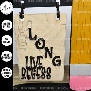 May include: A wooden sign with the words "Long Live Recess" in black letters. The sign is decorated with a drawing of a slide and a pencil.