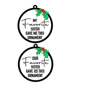 May include: Two black and white Christmas ornaments with a holly design and the text "My Favorite Sister Gave Me This Ornament" and "Our Favorite Sister Gave Us This Ornament".