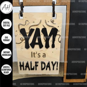 May include: A wooden sign with the words "Yay! It's a Half Day!" in black lettering. The sign is decorated with confetti and streamers.