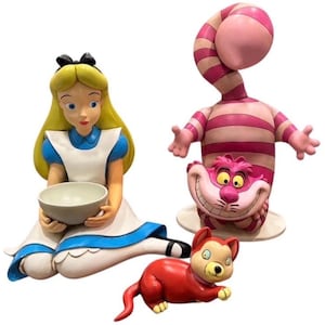 May include: A white ceramic mug with a black handle and the text "But First, Coffee" in a black, handwritten-style font. The mug is on a white surface.