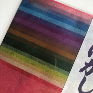 May include: A collection of 18 different colored paper strips, each with a unique texture and shade. The colors range from deep red to light blue, with shades of green, brown, and purple in between.
