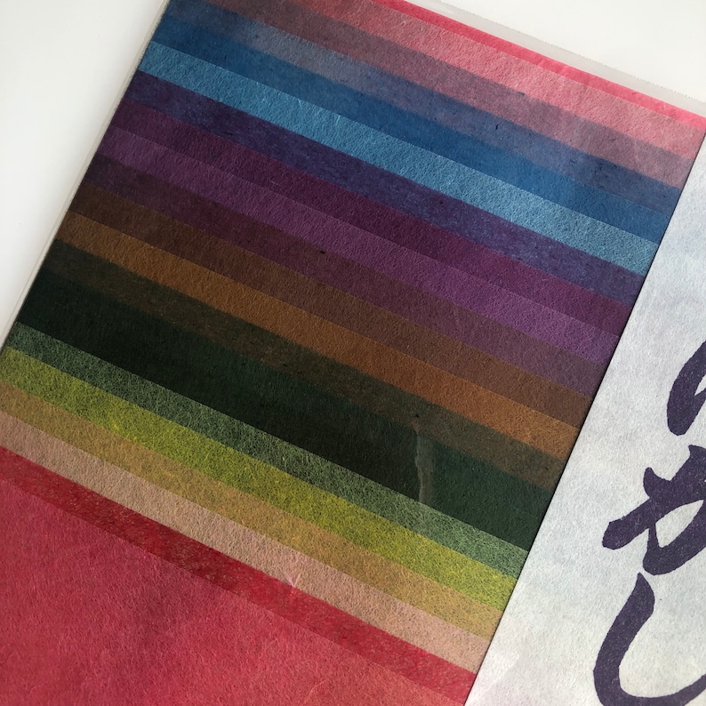 May include: A collection of 18 different colored paper strips, each with a unique texture and shade. The colors range from deep red to light blue, with shades of green, brown, and purple in between.