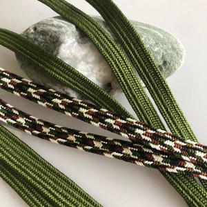 May include: Four different green cords, two are plain and two are patterned with brown, white, and black threads.