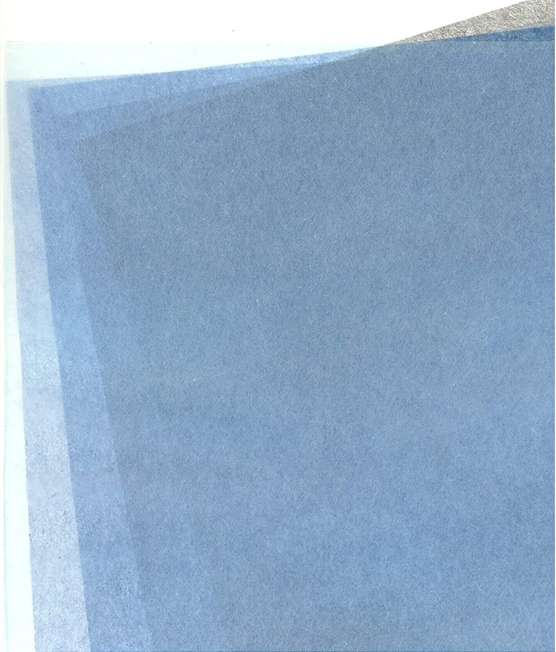 May include: A sheet of light blue tissue paper with a subtle textured surface.