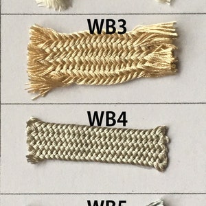 May include: A collection of six braided cords in various colors. The cords are labeled WB1 through WB6. Colors include off-white, beige, gold, light gray, dark gray, and black. Each cord has a frayed edge.