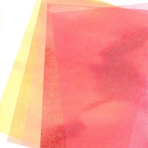 May include: Four sheets of translucent paper layered on top of each other. The top sheet is a vibrant red, the second sheet is a lighter orange, the third sheet is a pale yellow, and the bottom sheet is a very light yellow.
