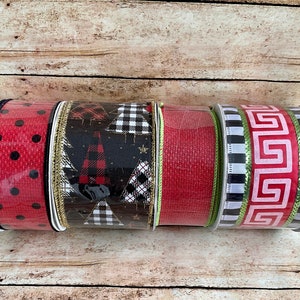May include: Five rolls of decorative ribbon in various patterns. The rolls include red with black polka dots, black with Christmas trees, solid red, and black and white geometric designs. The ribbons are on a wooden surface.
