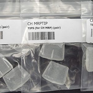 May include: Three clear plastic bags each containing several small, square, translucent tips. Each bag has a label with the text "CH MRPTIP TIPS (for CH MRP) (pair)" and a barcode.