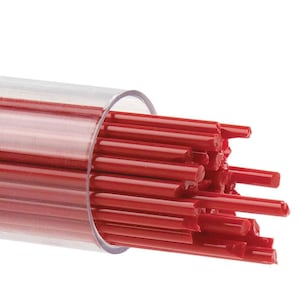 May include: A clear plastic tube filled with numerous red, cylindrical sticks. The sticks are tightly packed together, with some extending slightly beyond the tube's opening. The background is plain white, highlighting the vibrant red color of the sticks.