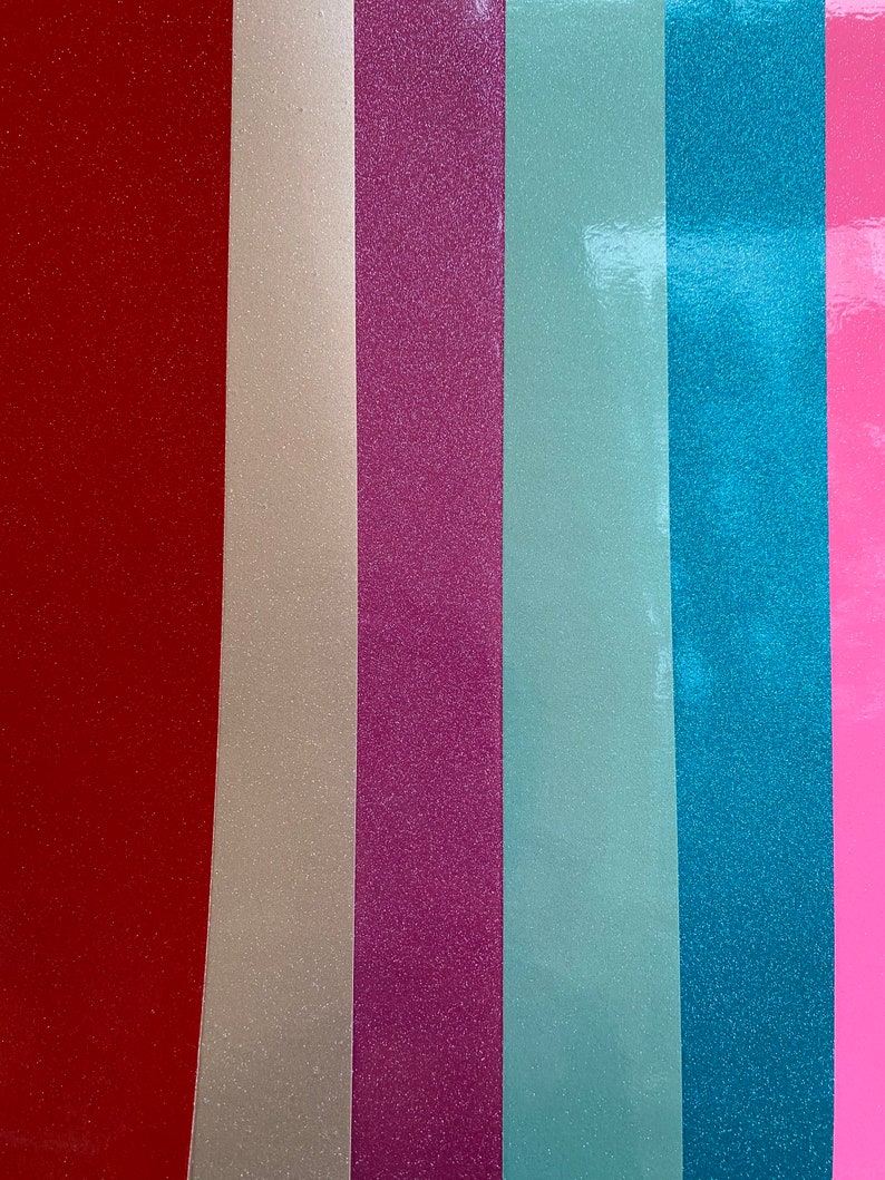 May include: Six vertical strips of glitter paper in different colors: red, beige, pink, light blue, teal, and pink.