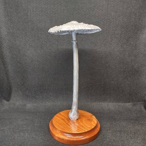 Tall Parasol Mushroom cast in aluminum displayed on a stained wood base
