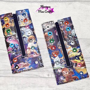May include: Two fabric zipper pouches with a Star Wars theme. The pouches are black with a blue background and feature various Star Wars characters and spaceships. The pouches have multiple colourful eyelets along the edges.