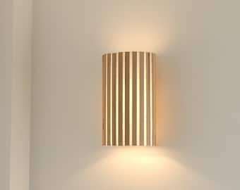 Estrée, a new collection of handmade wall lights. Original wall lamps made of wooden slats on fabric.