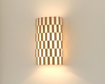 Estrée, a new collection of wall lights made of wood on fabric. An original range of refined, hand-crafted lighting.