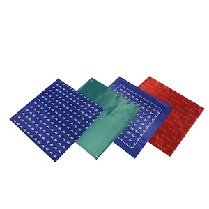 May include: Four different patterned fabric squares. One square is blue with a white pattern, one is green, one is blue with a white pattern, and one is red.