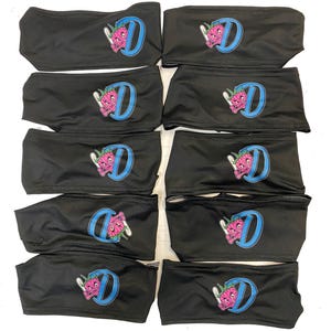 May include: Ten black headbands with a blue and pink cartoon character design. The character is holding a marijuana leaf and the letter "D" is in the background.