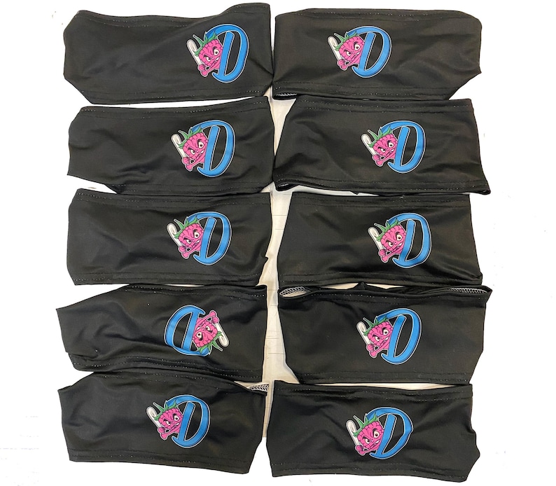 May include: Ten black headbands with a blue and pink cartoon character design. The character is holding a marijuana leaf and the letter "D" is in the background.