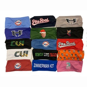 May include: A collection of 15 colorful headbands with various designs and text. Some headbands feature logos, others have text like "Pike Road", "Women Life Freedom", and "Zimmerman #27".