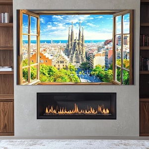 Könnte beinhalten: Ein großer, gerahmter Leinwanddruck, der einen Blick auf die Sagrada Familia in Barcelona, Spanien, durch ein offenes Fenster zeigt. Der Fensterrahmen hat einen warmen Holzton, und der Himmel ist blau mit flauschigen Wolken. Der Druck ist über einem Kamin angebracht.