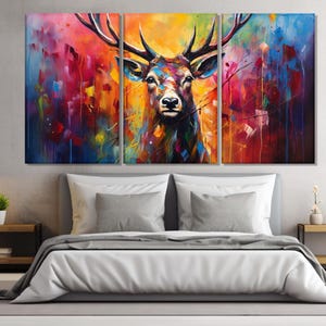 May include: A colourful abstract painting of a deer with large antlers. The background is a mix of vibrant colours, including blue, red, yellow, and green.