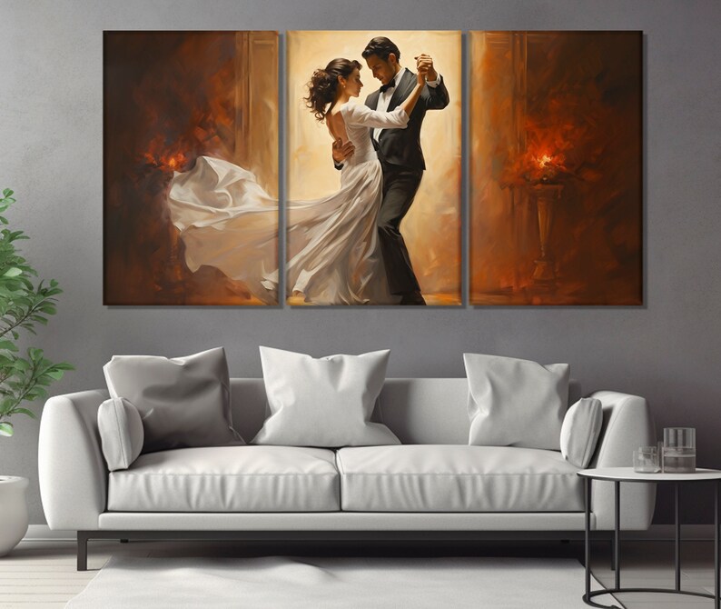 May include: A painting of a couple dancing in a ballroom. The man is wearing a black suit and the woman is wearing a white dress. The background is a warm, golden color.
