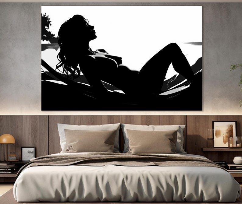 May include: Black and white silhouette of a person lying down on a bed of leaves. The person's face is turned to the side and their eyes are closed. The background is white.