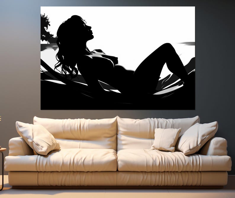 May include: Black and white silhouette of a person lying on a bed with their head turned to the side. The person is nude and the background is white.