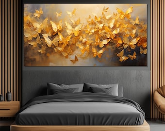 May include: A large rectangular canvas art piece featuring numerous golden butterflies against a muted background of blues, browns, and yellows. The butterflies appear to be in flight, creating a dynamic and visually appealing composition.