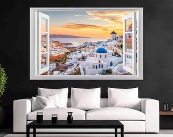 May include: A white framed window with a view of a white city with blue domed buildings and a sunset over the ocean.