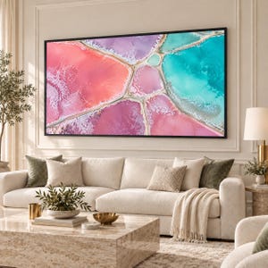 May include: A large rectangular wall art piece featuring an aerial view of salt ponds with vibrant sections of pink, purple, and turquoise water separated by white crystalline borders, enclosed in a thin black frame.