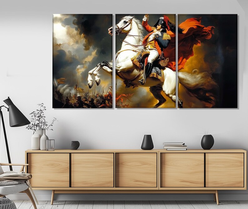 May include: A three-panel canvas print depicting a man on horseback. The man is wearing a red and white uniform and a bicorne hat. The horse is white and is rearing up on its hind legs. The background is a dramatic sky with clouds.