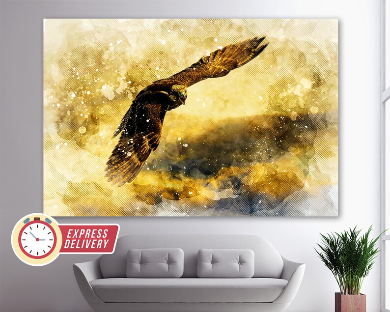May include: A watercolor painting of a golden eagle in flight against a yellow and blue background. The eagle is in sharp focus, while the background is blurred and has a watercolor effect.