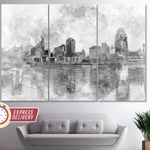May include: A black and white watercolor painting of a city skyline with a bridge in the foreground. The city is reflected in the water below. The painting has a textured, brushstroke effect.