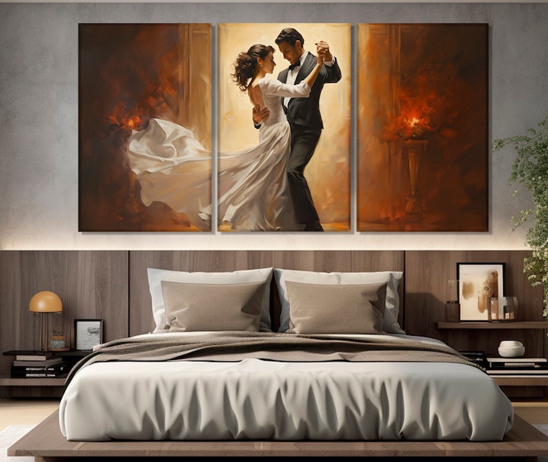 May include: A painting of a couple dancing in a ballroom. The man is wearing a black tuxedo and the woman is wearing a white gown. The background is a warm, golden color.