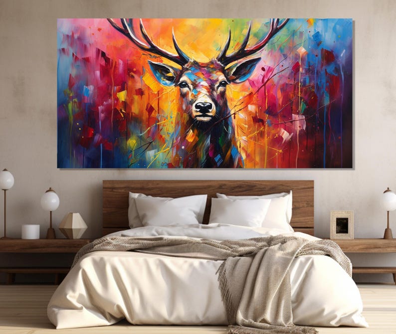 May include: A colourful abstract painting of a deer with large antlers. The background is a mix of bright colours, including blue, red, yellow, and green.
