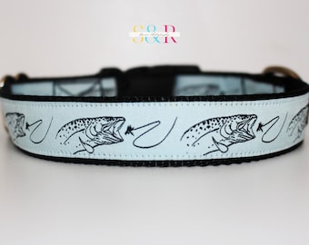 May include: A light blue dog collar with a black border and a repeating pattern of black trout silhouettes with fishing flies.