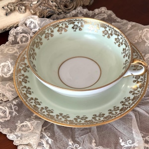 Rare and beautiful vintage Limoges porcelain cup and saucer. 1950s-60s. Pale celadon green with floral gilt. 300 ml.
