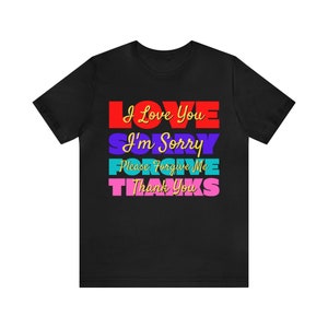 May include: Black t-shirt with a colorful graphic design that reads "I Love You I'm Sorry Please Forgive Me Thank You".